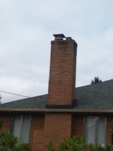 Photo of chimney with double flue which is associated with heating oil tanks