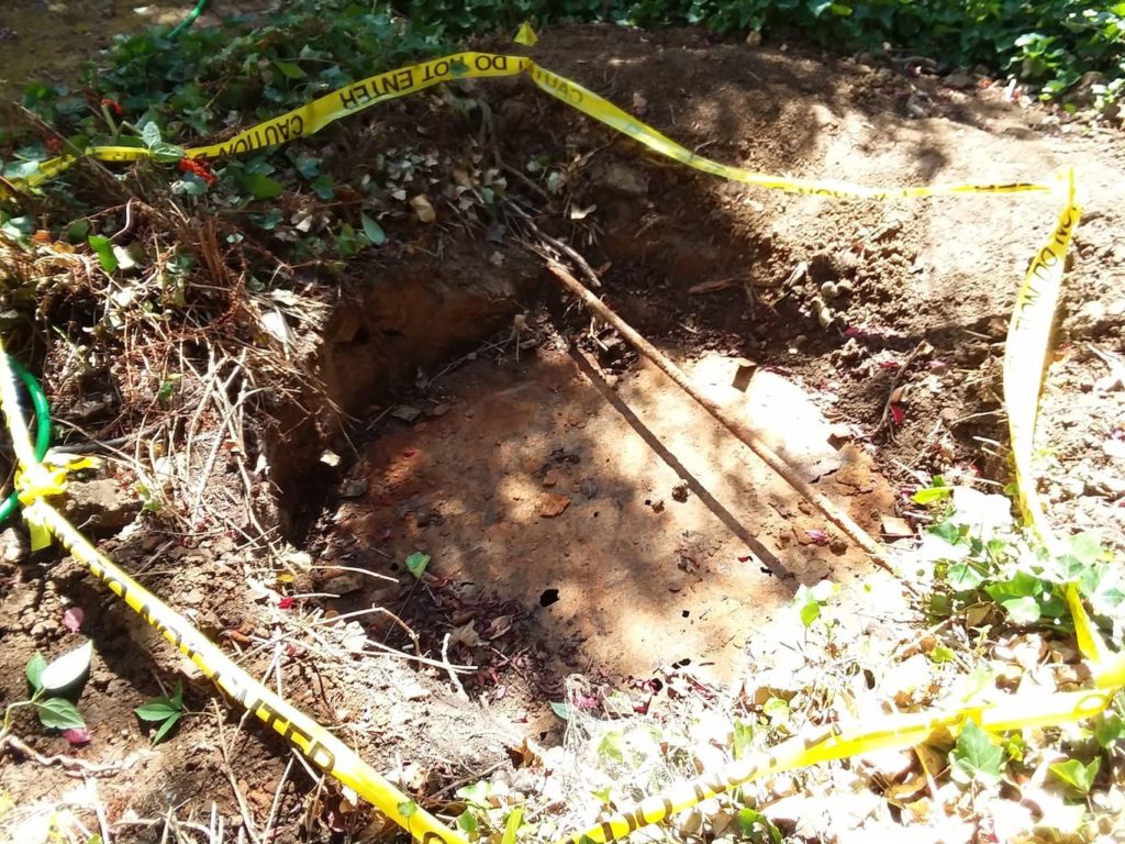 Photo of a failing metal topped septic tank service hatch